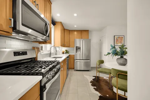 a kitchen with a sink appliances and cabinets