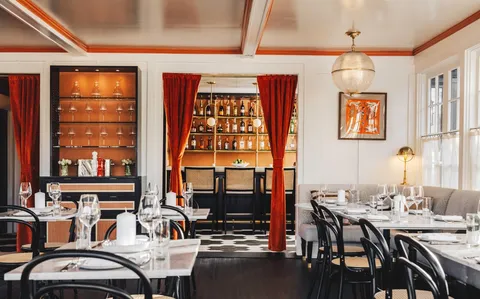 a view of a dining room with furniture and window