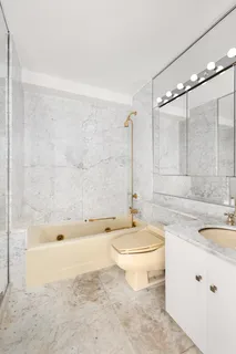 a bathroom with a sink a toilet and bathtub