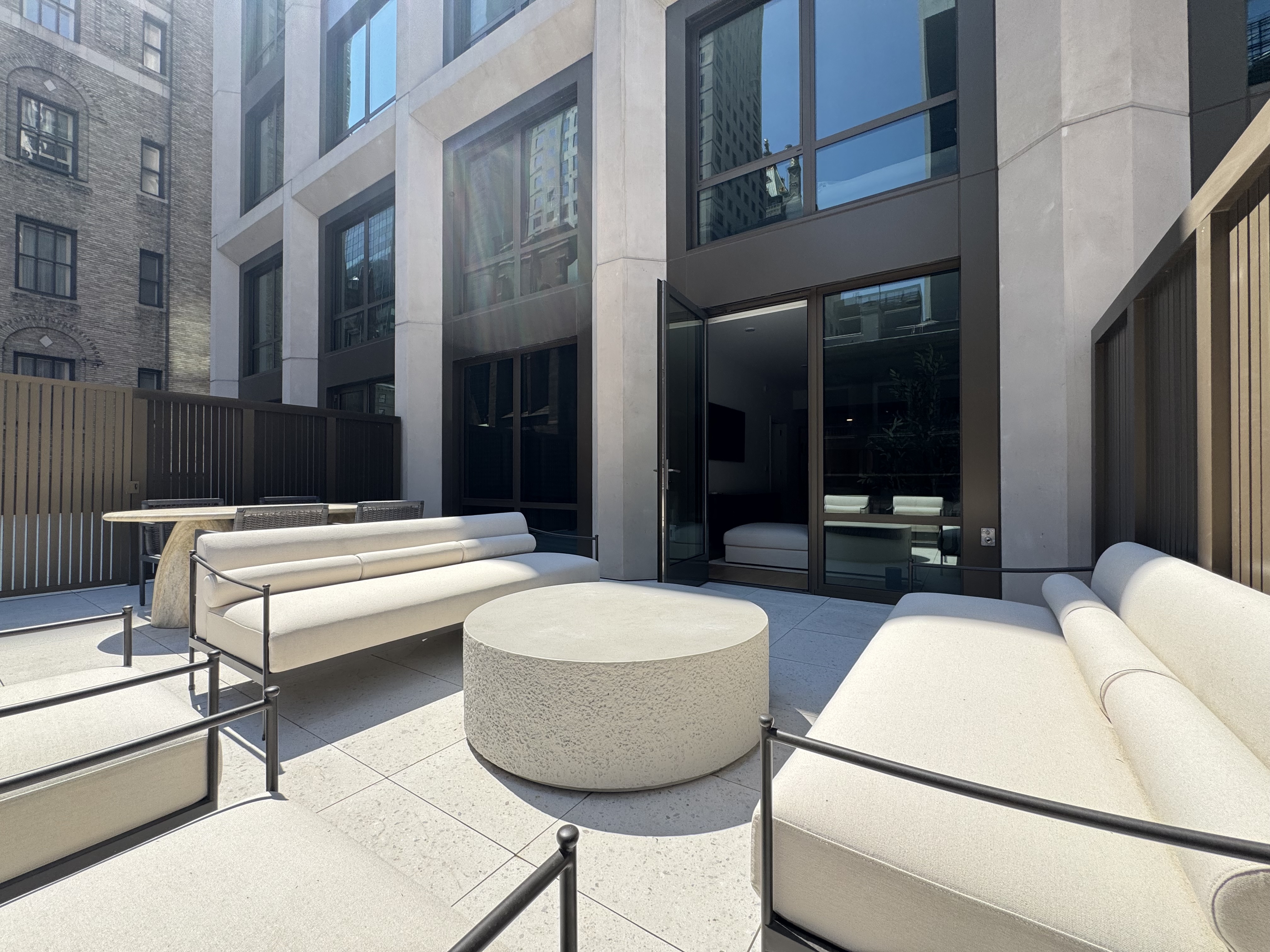 18 West 55th Street, Unit 7B Manhattan, NY 10019 - Photo 3 of 20 a view of a patio with a couch and chairs