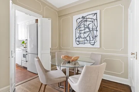 a dining room with furniture and wooden floor