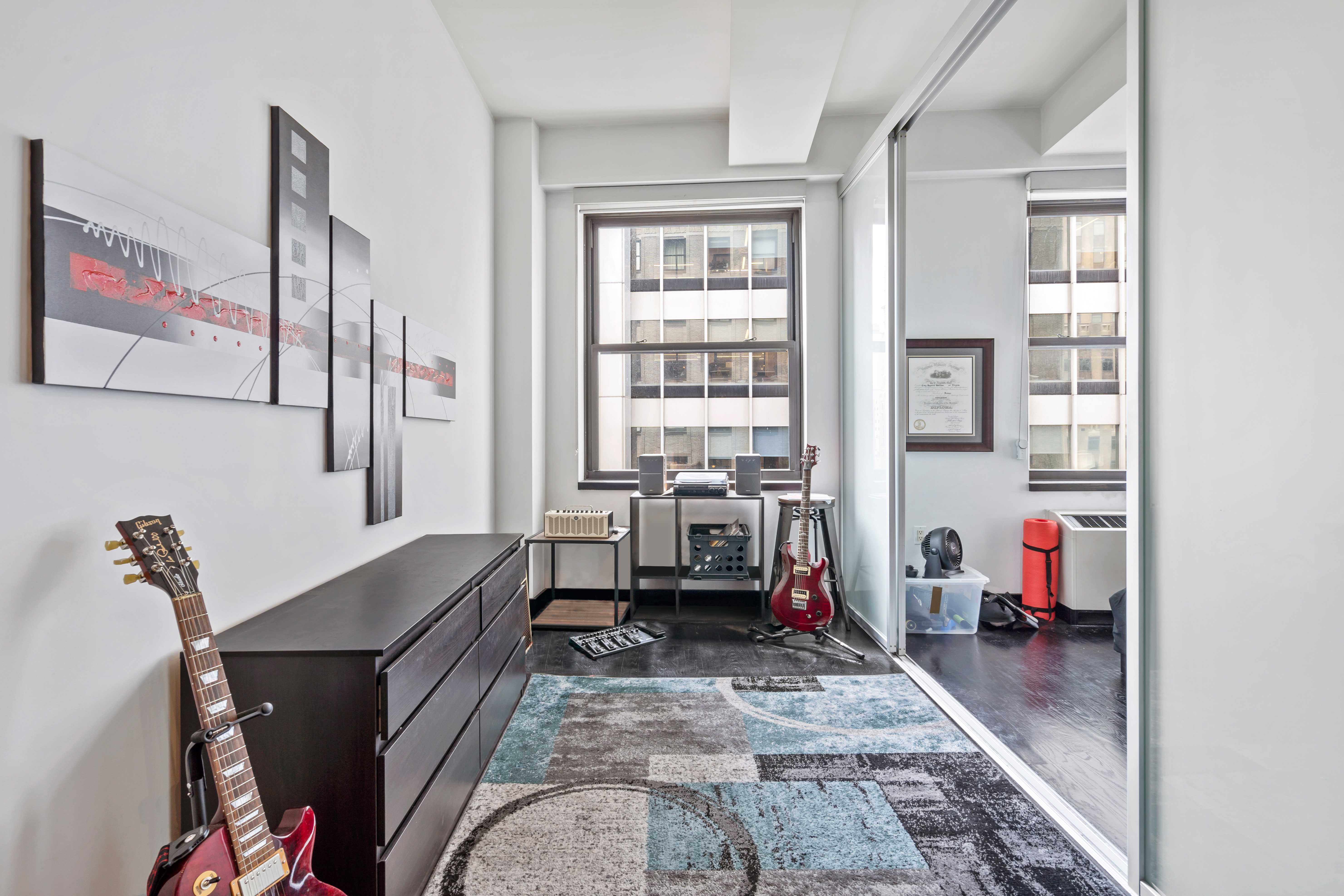 20 Pine Street, Unit 2012 Manhattan, NY 10005 - Photo 4 of 25 a living room with furniture and a window