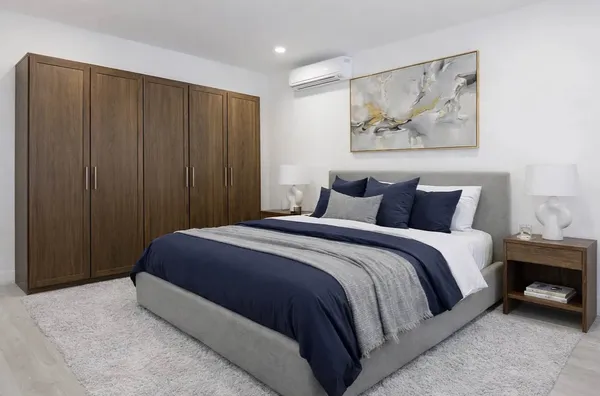 a bedroom with a bed and a wall painting