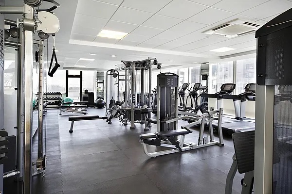 220 East 65th Street, Unit 8J Manhattan, NY 10065 - Photo 8 of 13 a view of a room with gym equipment