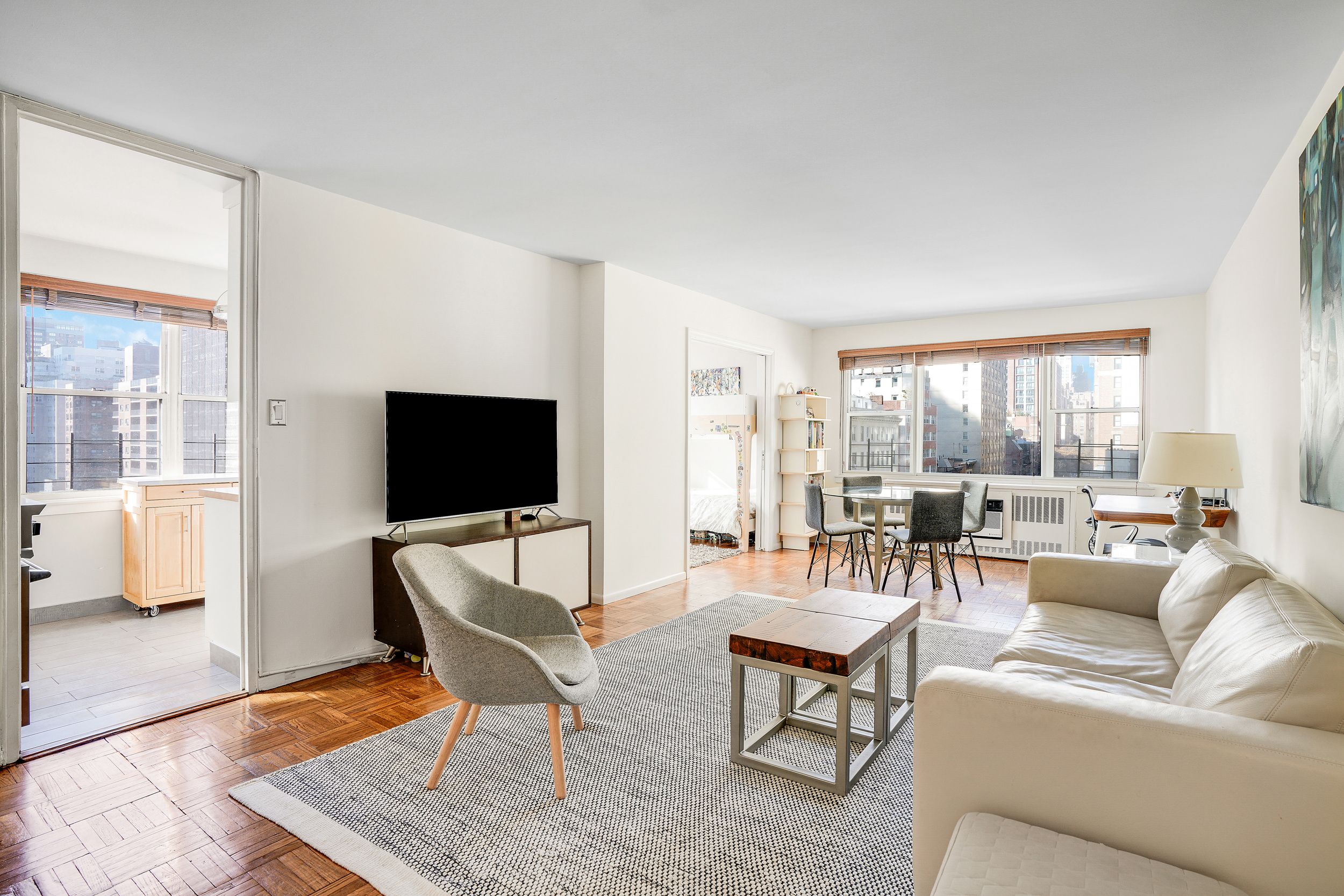 201 East 37th Street, Unit 11D Manhattan, NY 10016 - Photo 1 of 11 a living room with furniture and a flat screen tv