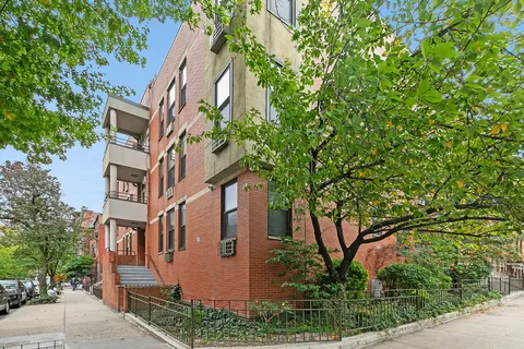 front view of a house with a tree