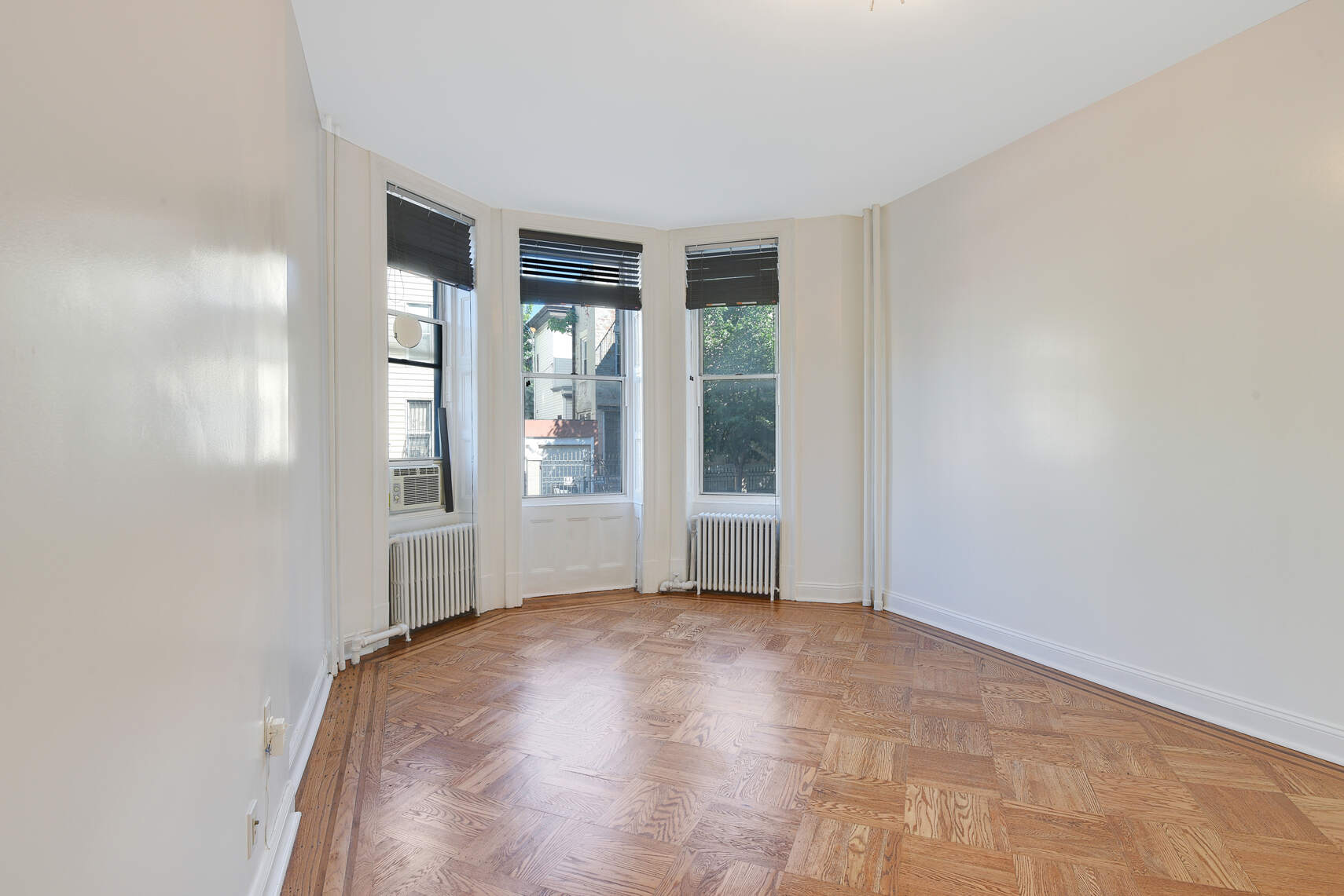 514 Hart Street, Unit PARLOR Brooklyn, NY 11221 - Photo 6 of 9 an empty room with windows