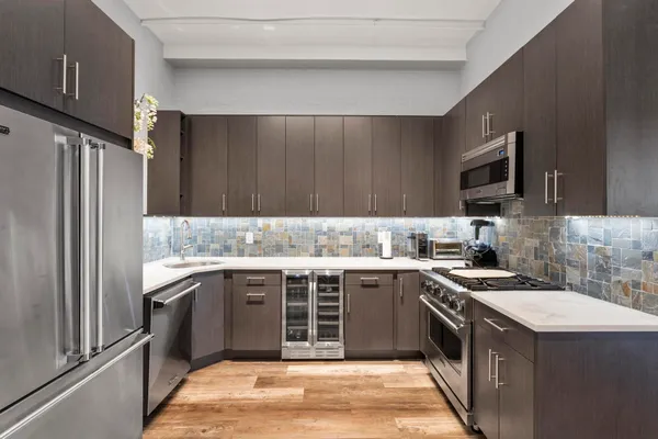 a kitchen with a sink stove and refrigerator