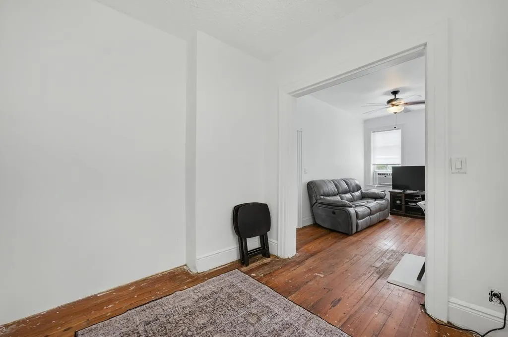 a living room with furniture and a mirror