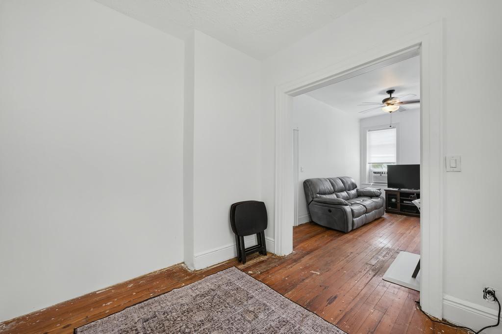 10 Seeley Street Brooklyn, NY 11218 - Photo 24 of 27 a living room with furniture and a mirror