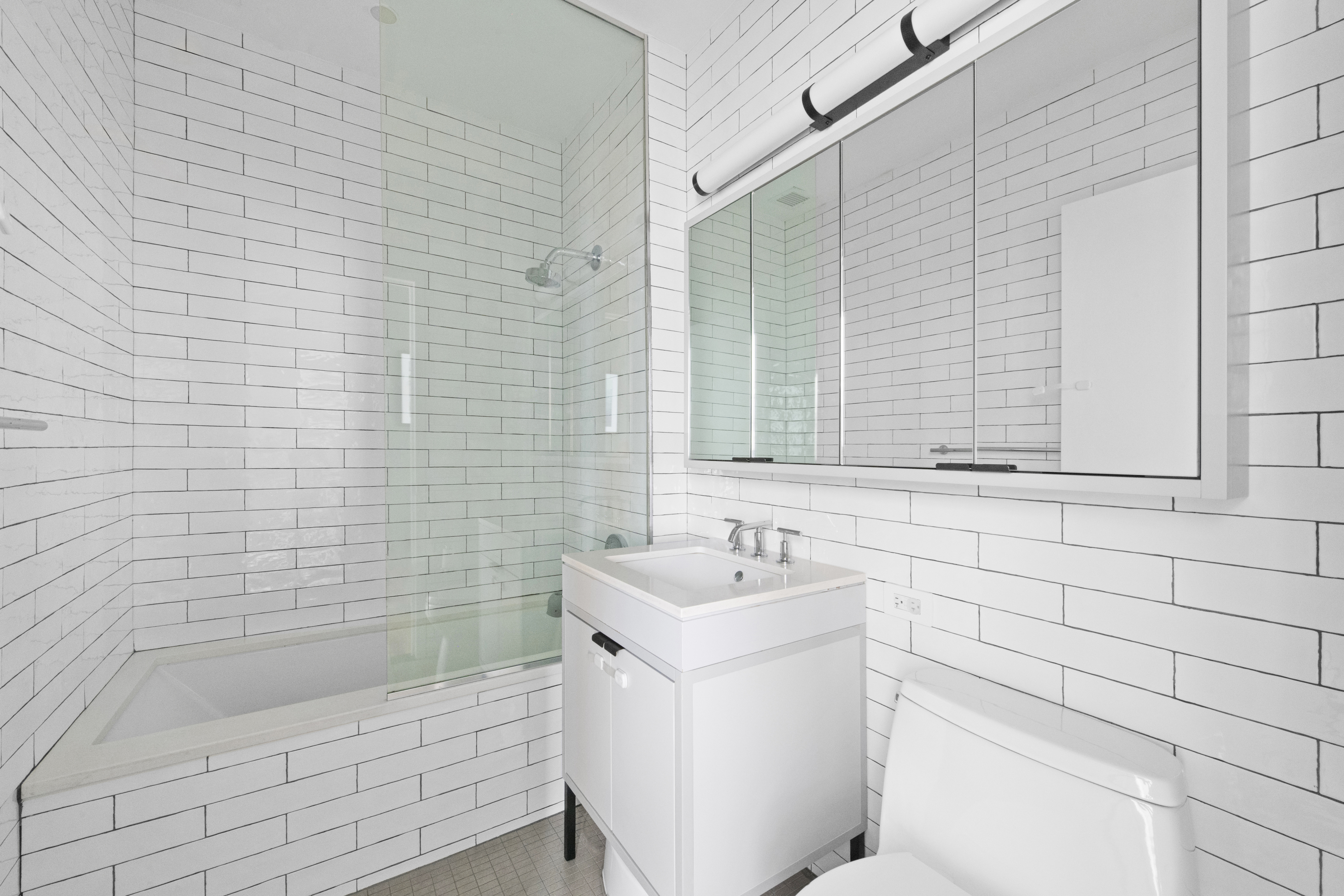184 Kent Avenue, Unit D315 Brooklyn, NY 11249 - Photo 8 of 19 a bathroom with a sink a toilet and shower