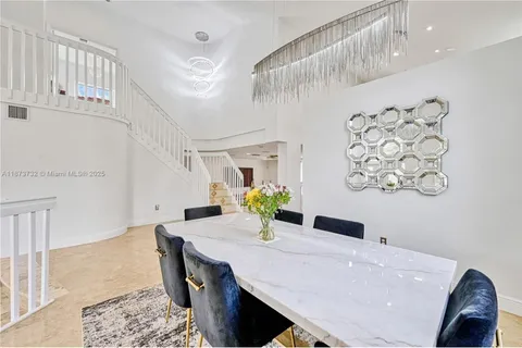 a view of a dining table and chairs