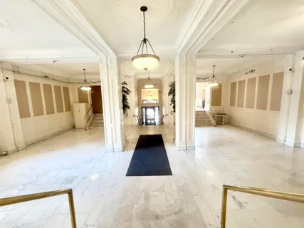 a view of a living room and chandelier