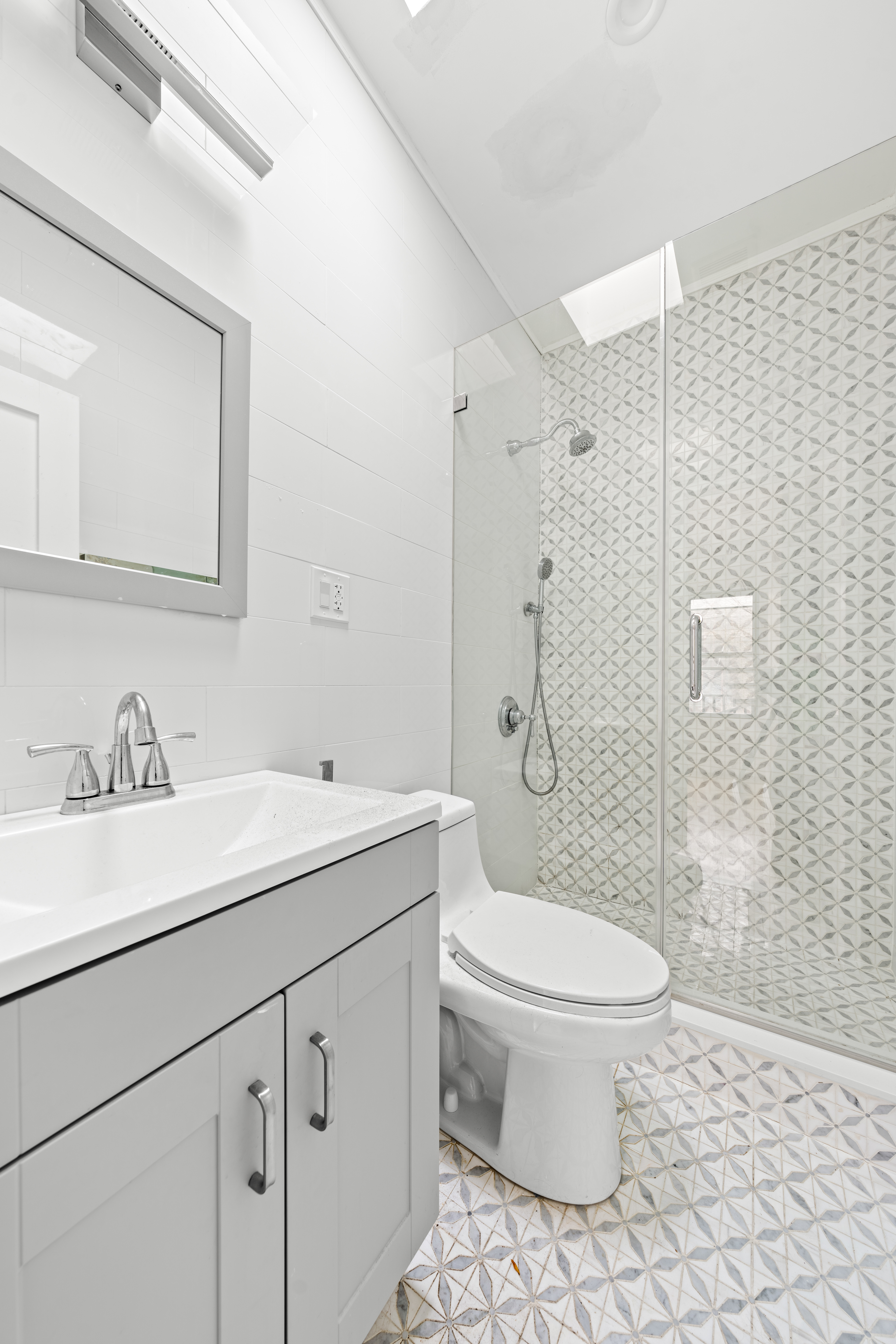 181 Park Avenue Brooklyn, NY 11205 - Photo 13 of 19 a bathroom with a sink toilet vanity and shower