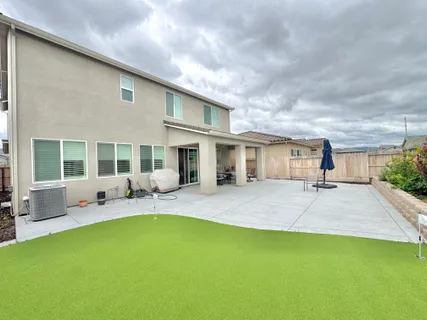 a house view with swimming pool and porch