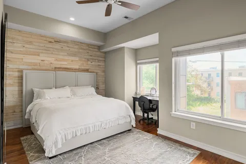 a bedroom with a large bed and a large window
