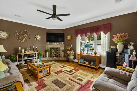 a living room with furniture a fireplace and a flat screen tv
