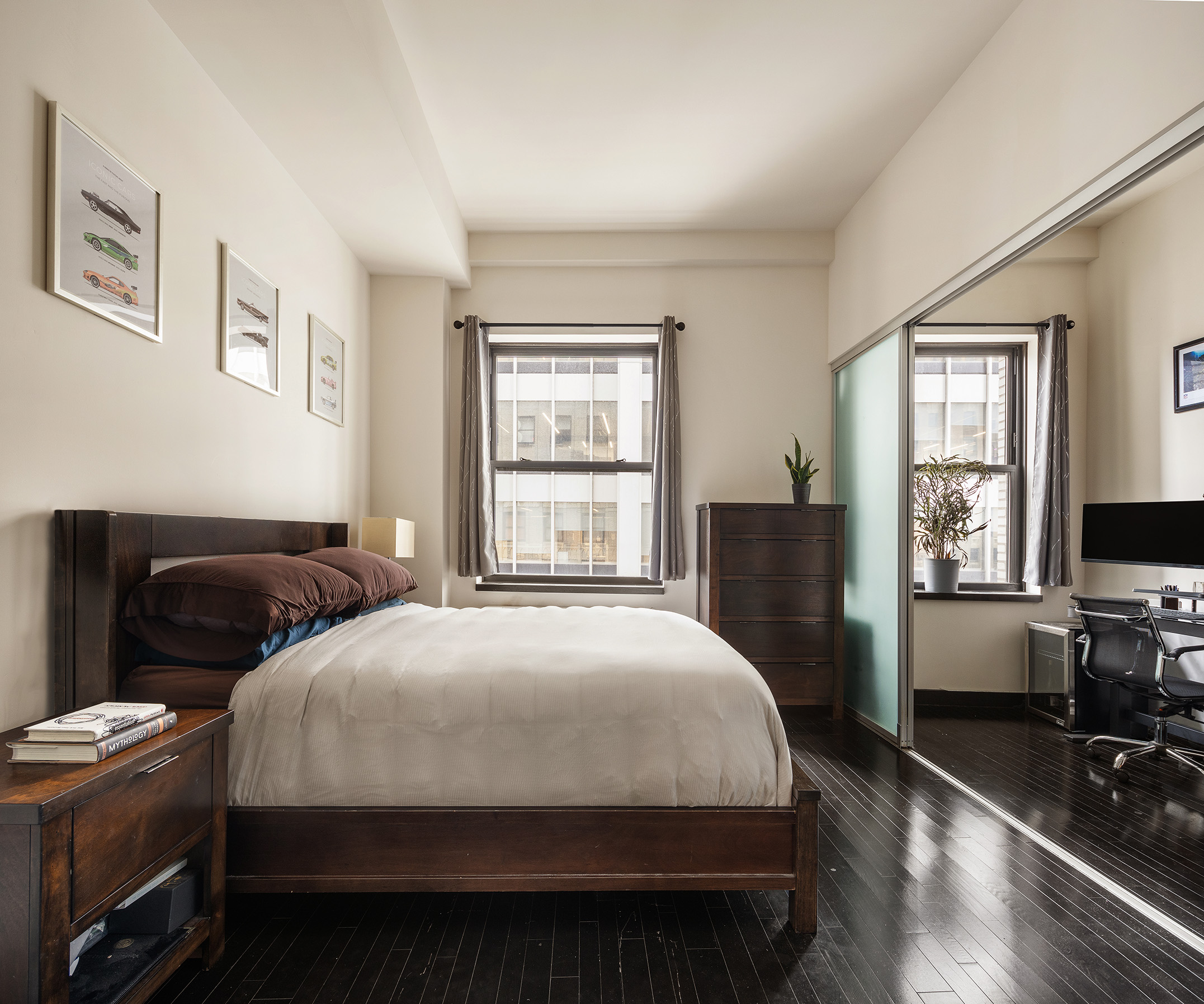 20 Pine Street, Unit 2413 Manhattan, NY 10005 - Photo 4 of 16 a bedroom with a bed and a tv on the dresser