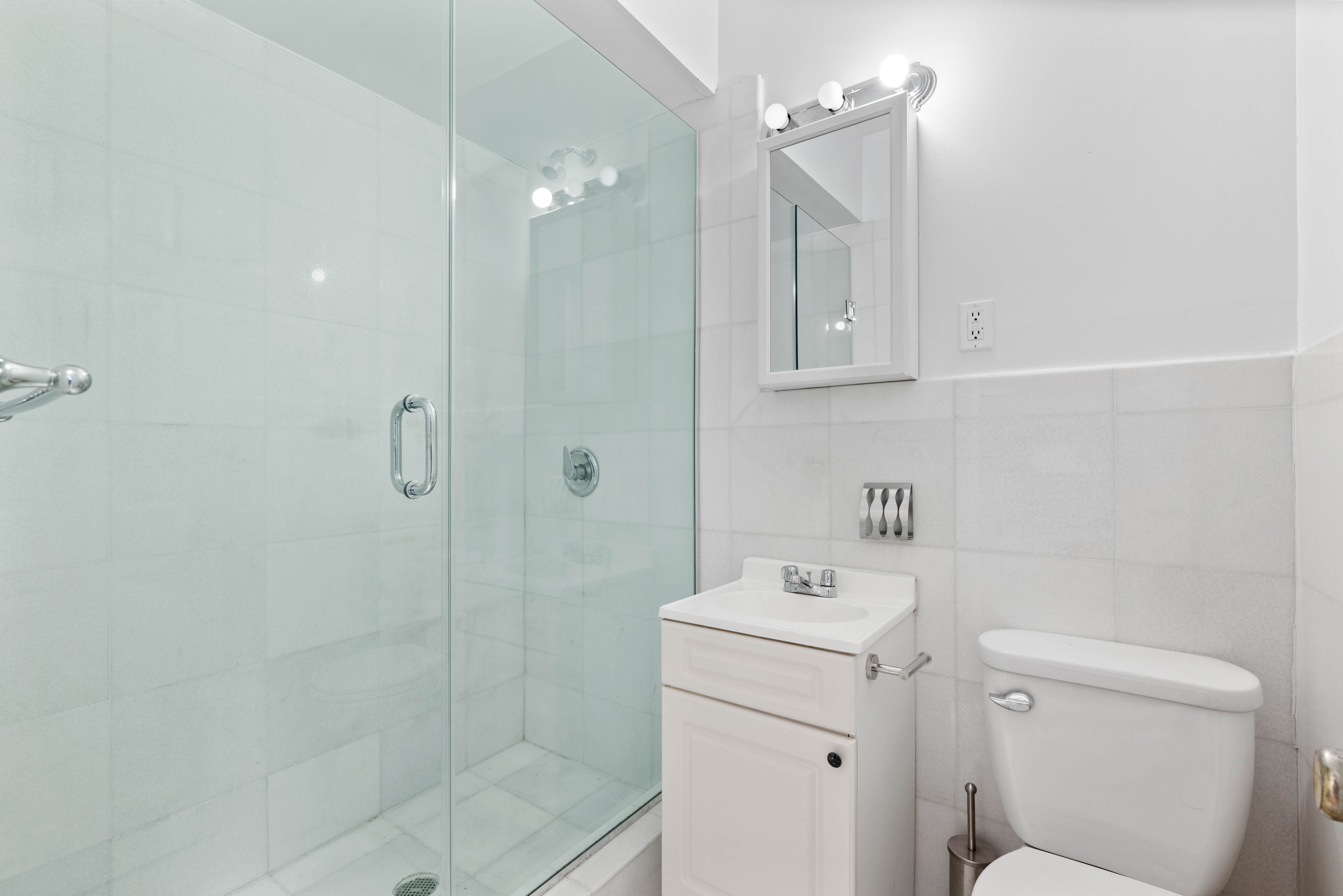 142 Sullivan Street, Unit 18 Manhattan, NY 10012 - Photo 9 of 11 a bathroom with a sink a toilet and shower
