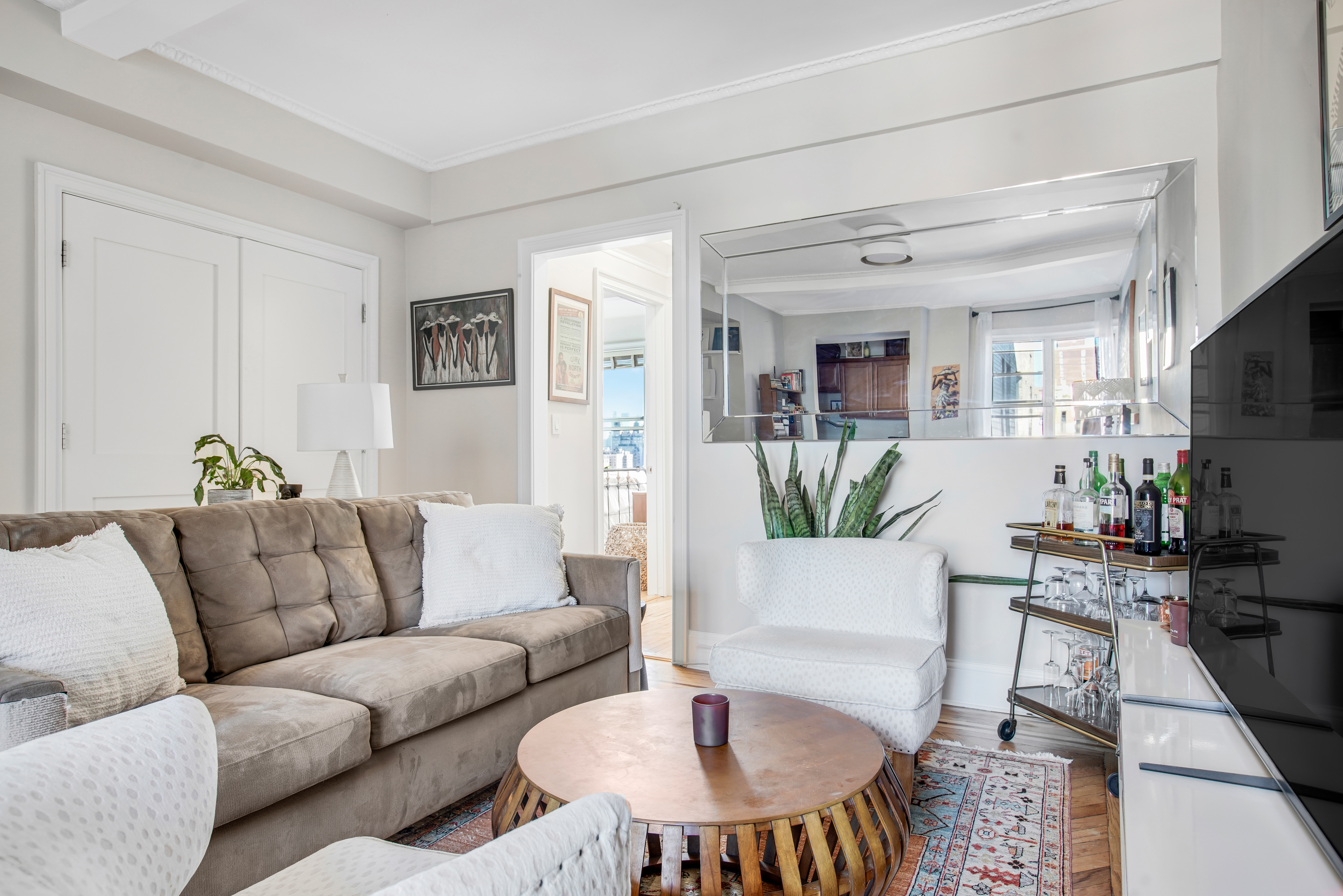 165 West 91st Street, Unit 15B Manhattan, NY 10024 - Photo 7 of 24 a living room with furniture a dining table and a chandelier