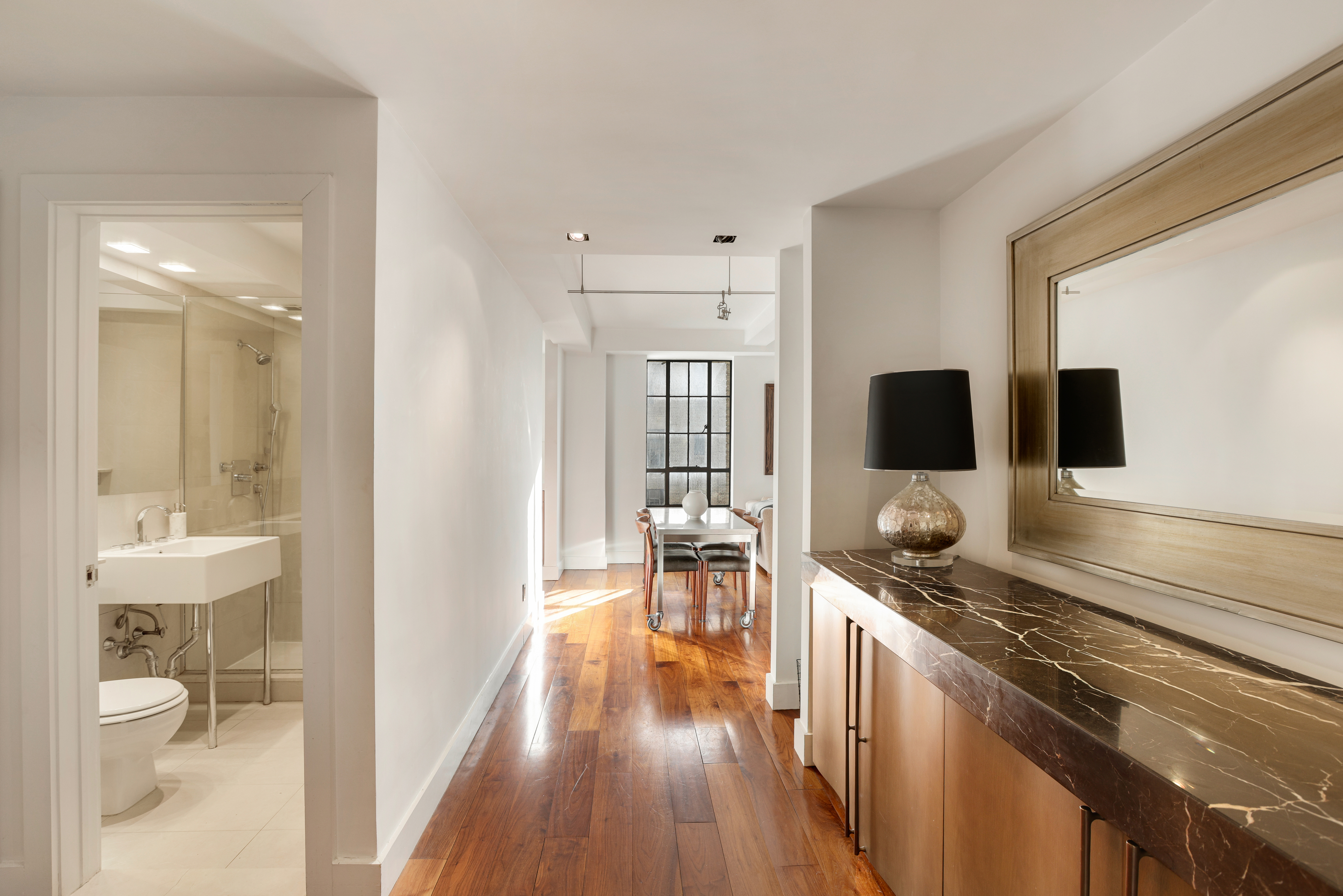 340 West 57th Street, Unit 8E Manhattan, NY 10019 - Photo 3 of 16 a kitchen with a table and chairs