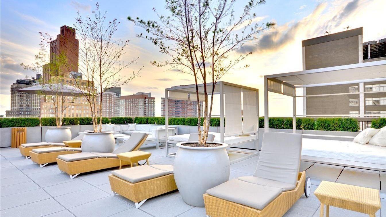 88 Greenwich Street, Unit 611 Manhattan, NY 10006 - Photo 1 of 10 a building outdoor space with patio chairs and a fire pit