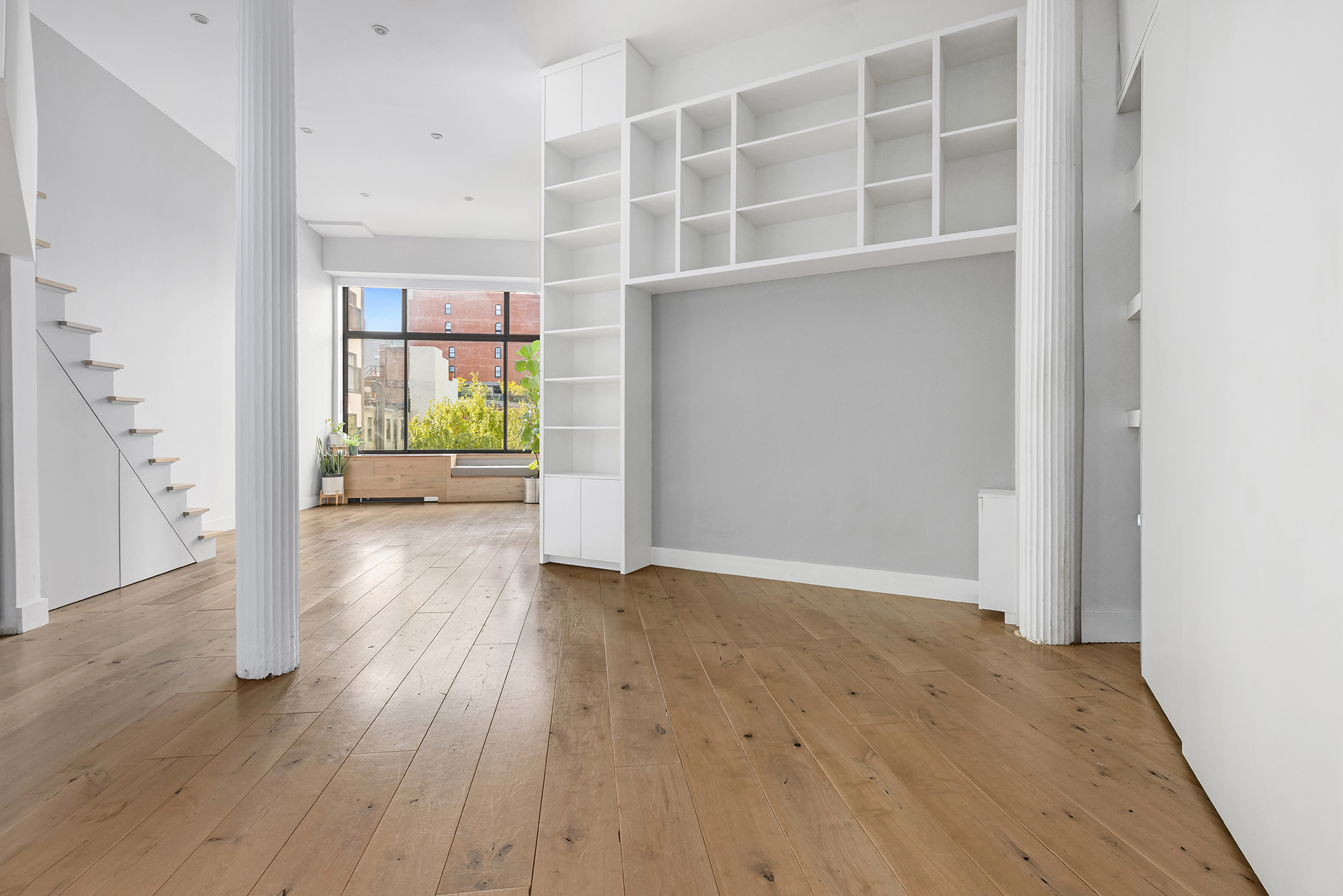 77 Bleecker Street, Unit 617 Manhattan, NY 10012 - Photo 4 of 13 an empty room with wooden floor and a window