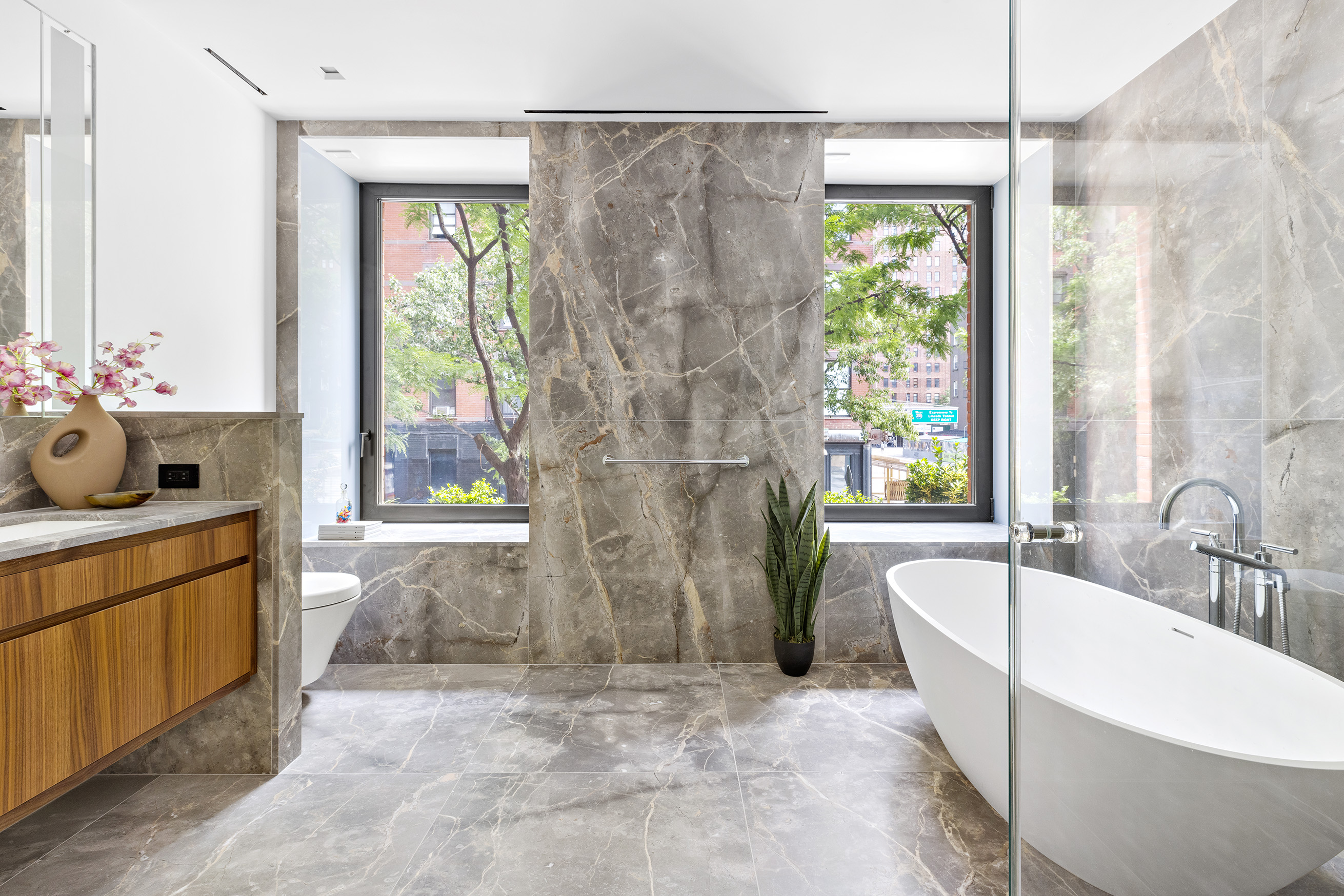 500 West 22nd Street, Unit 2A Manhattan, NY 10011 - Photo 9 of 19 a spacious bathroom with a tub sink and mirror