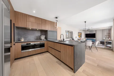 a kitchen with stainless steel appliances kitchen island granite countertop a stove and a sink