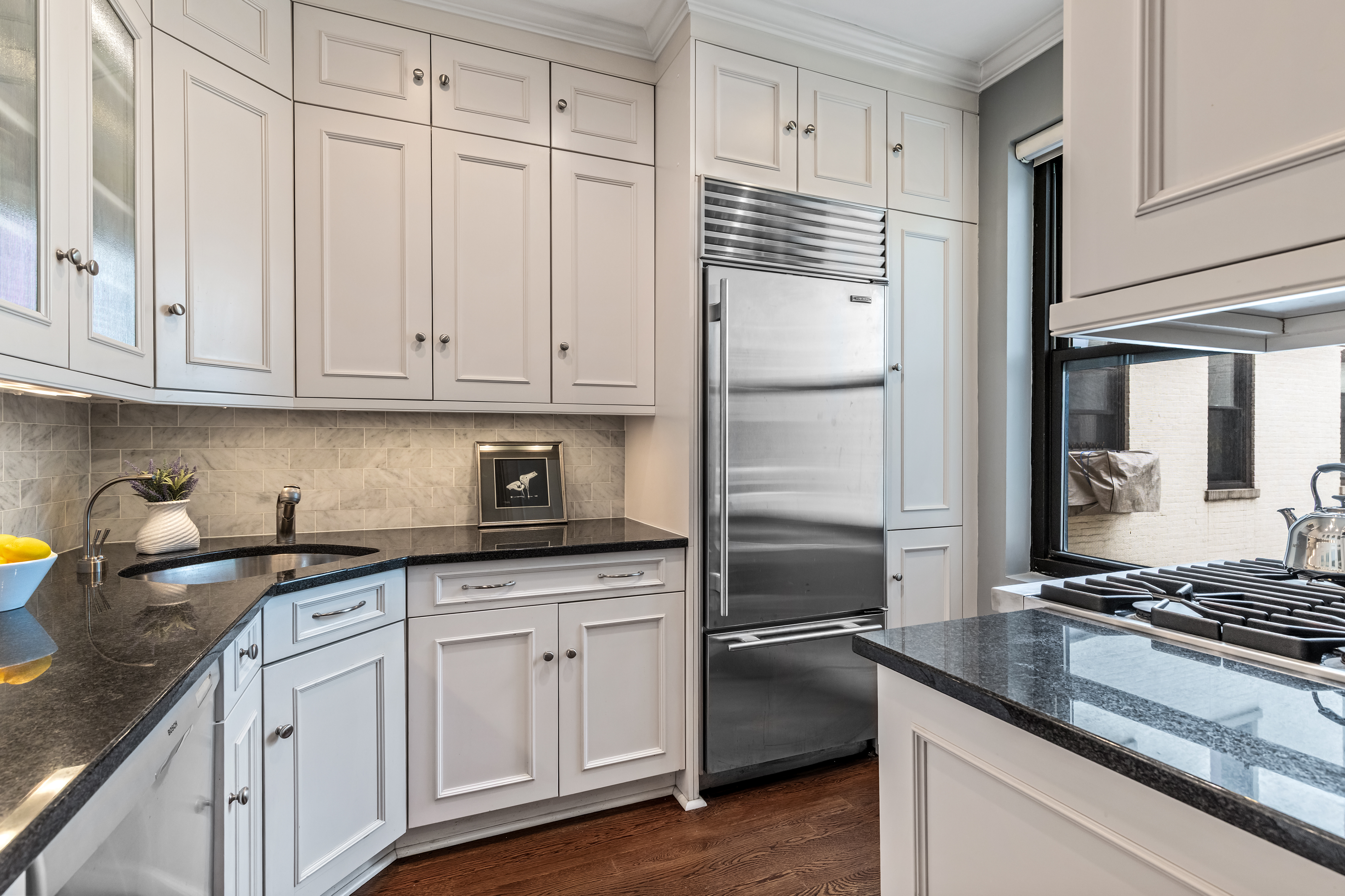 101 West 81st Street, Unit 601 Manhattan, NY 10024 - Photo 3 of 12 a kitchen with granite countertop a sink stainless steel appliances and cabinets