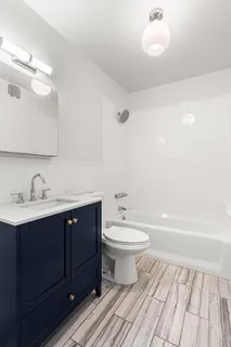 a bathroom with a toilet a sink and bathtub