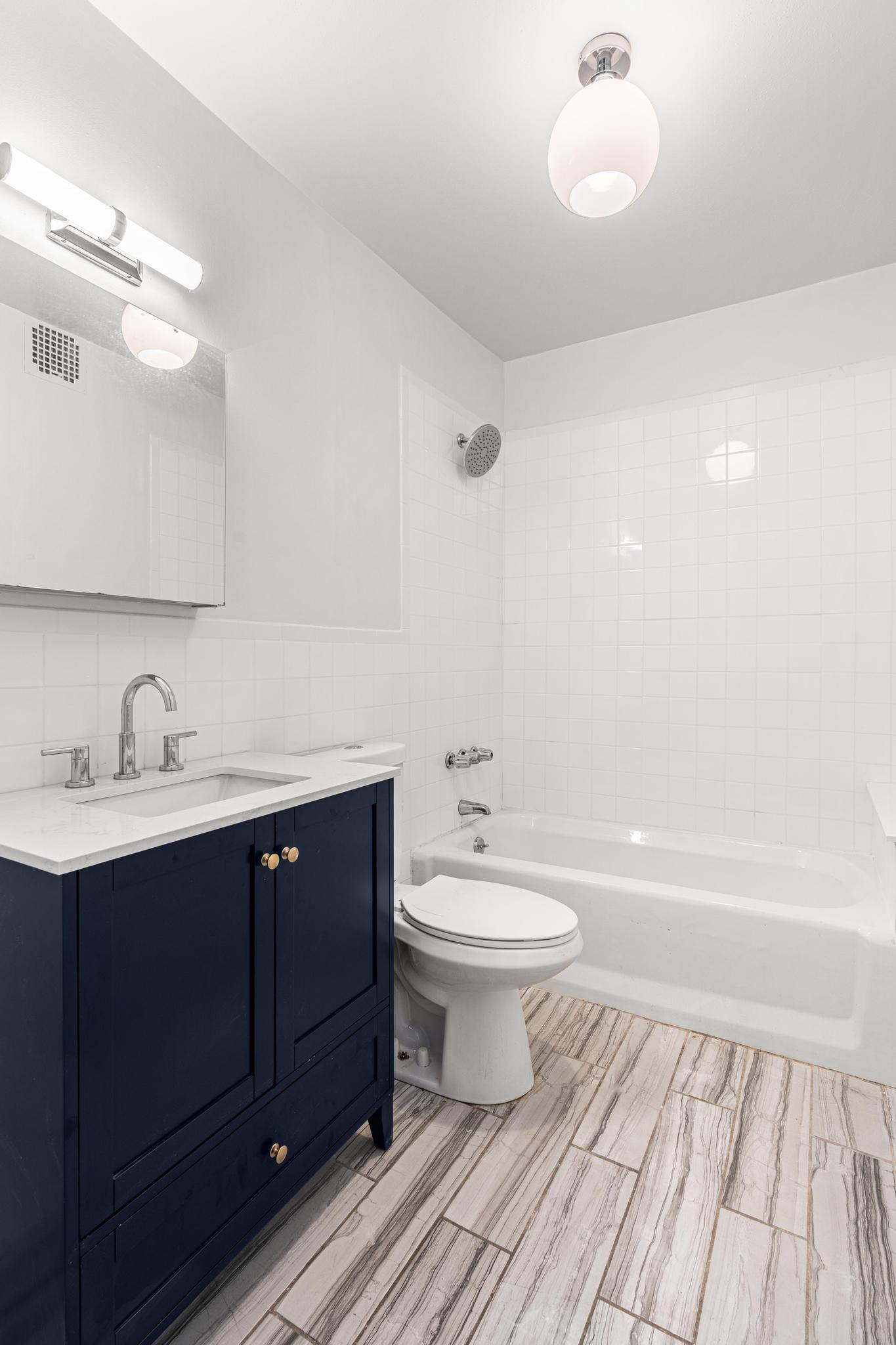 306 Lafayette Avenue, Unit 4 Brooklyn, NY 11238 - Photo 9 of 11 a bathroom with a toilet a sink and bathtub