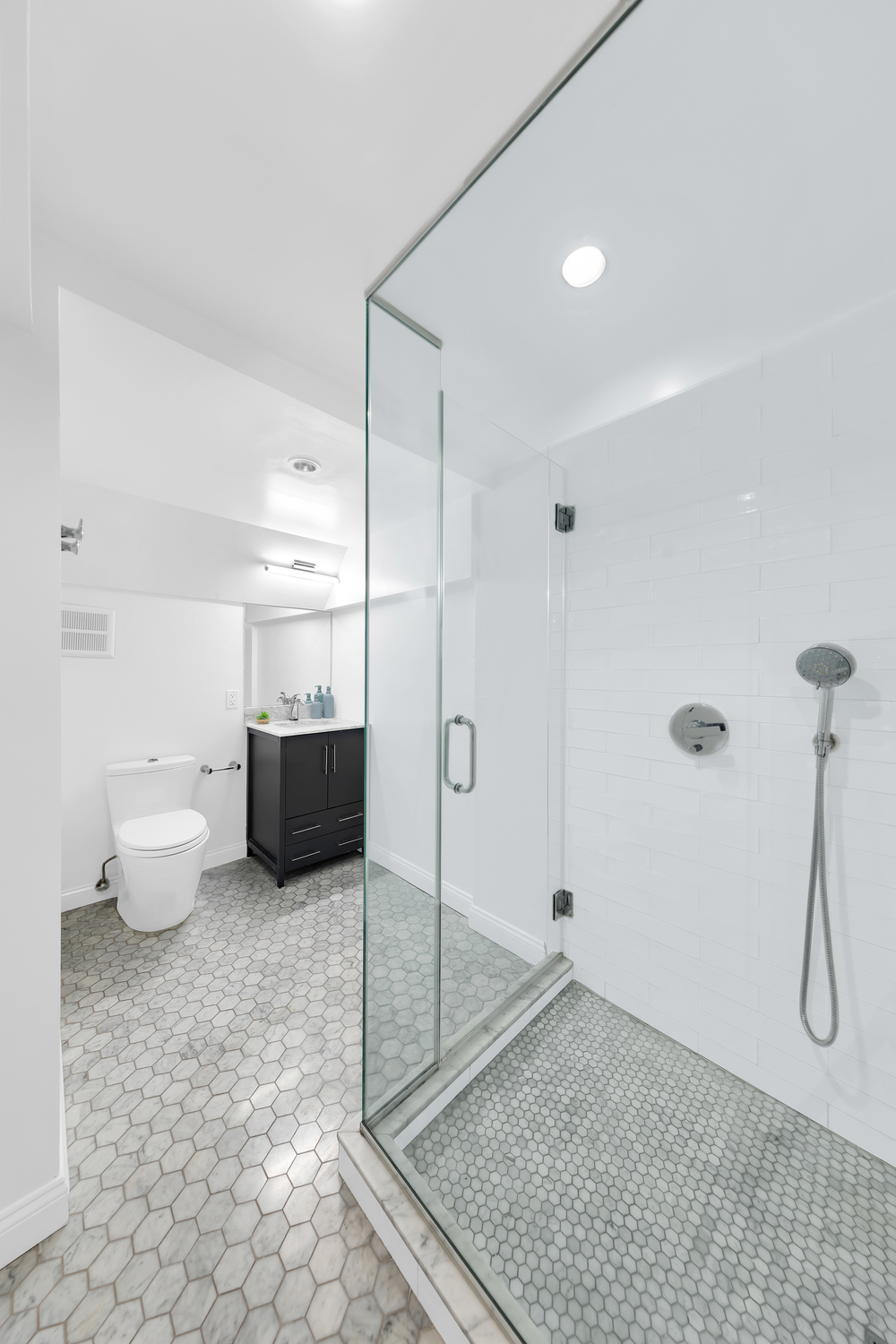 26 South Oxford Street, Unit 1A Brooklyn, NY 11217 - Photo 11 of 13 a bathroom with a granite countertop sink a toilet and a shower