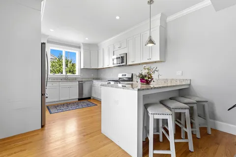 a kitchen with a sink cabinets and window