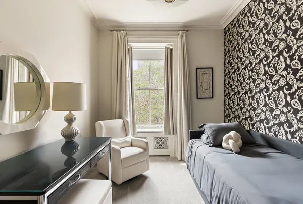 a living room with a bed furniture and a window