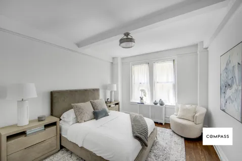 a bedroom with a bed and a couch