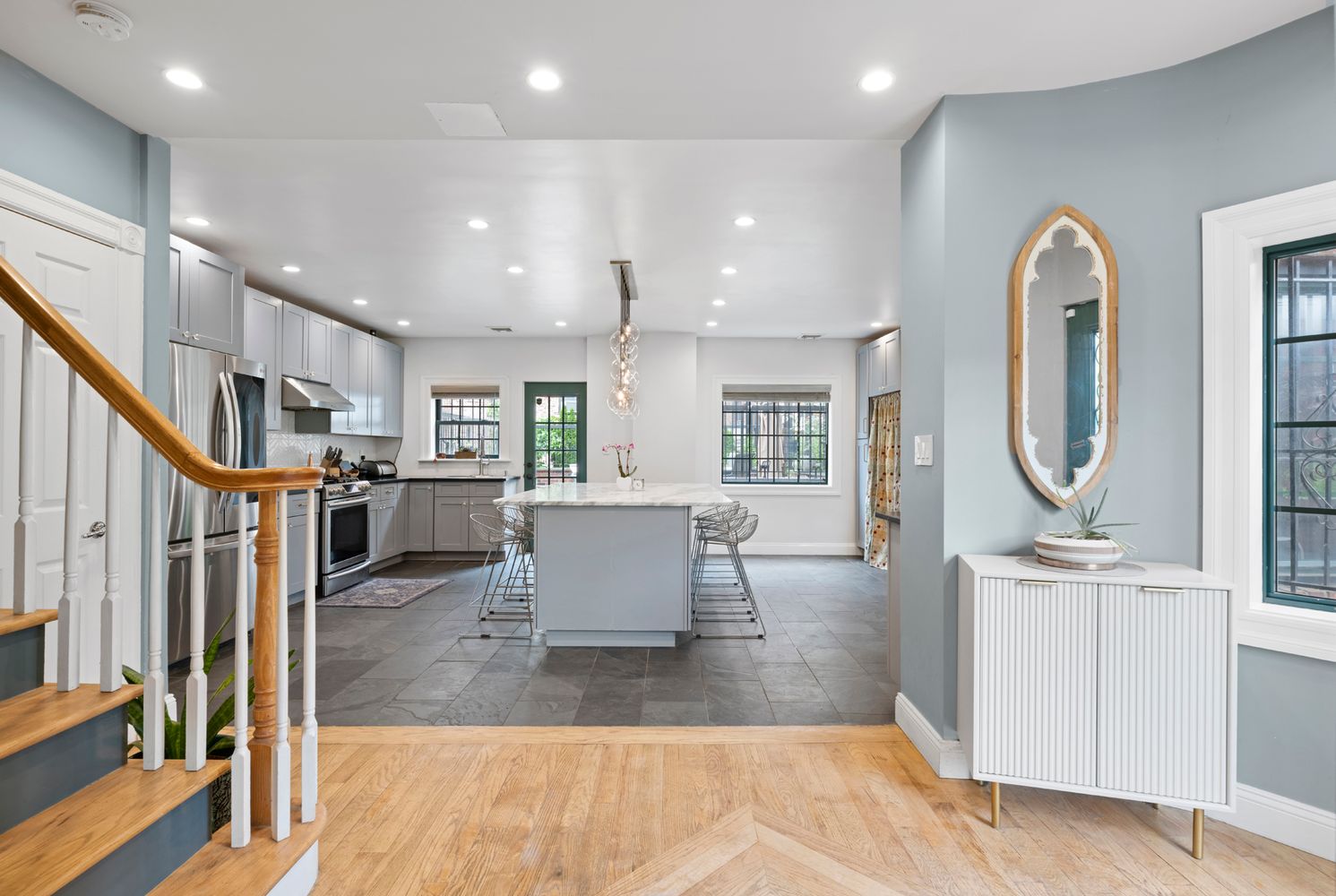 a living room with lots of furniture and a view of kitchen