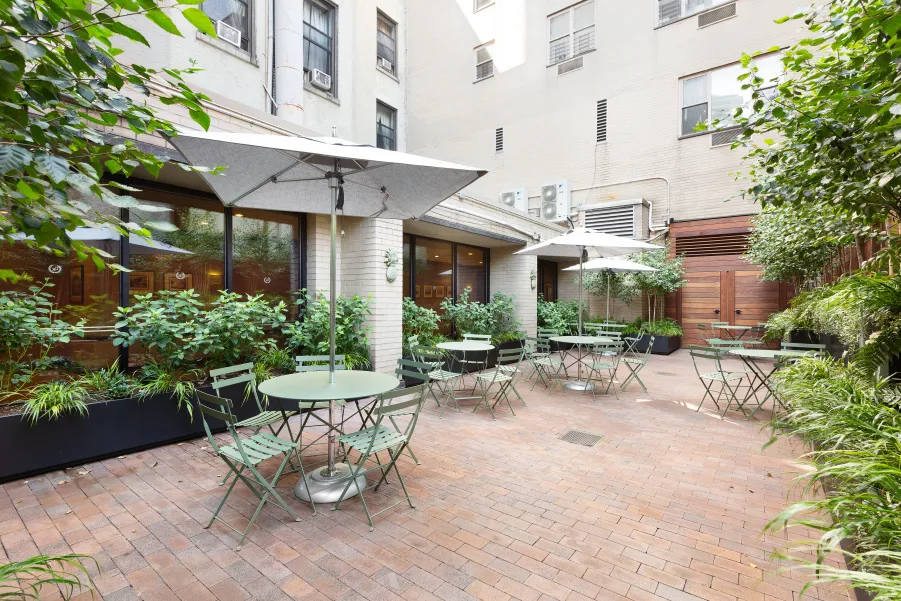 a view of a patio with a table and chairs and potted plants