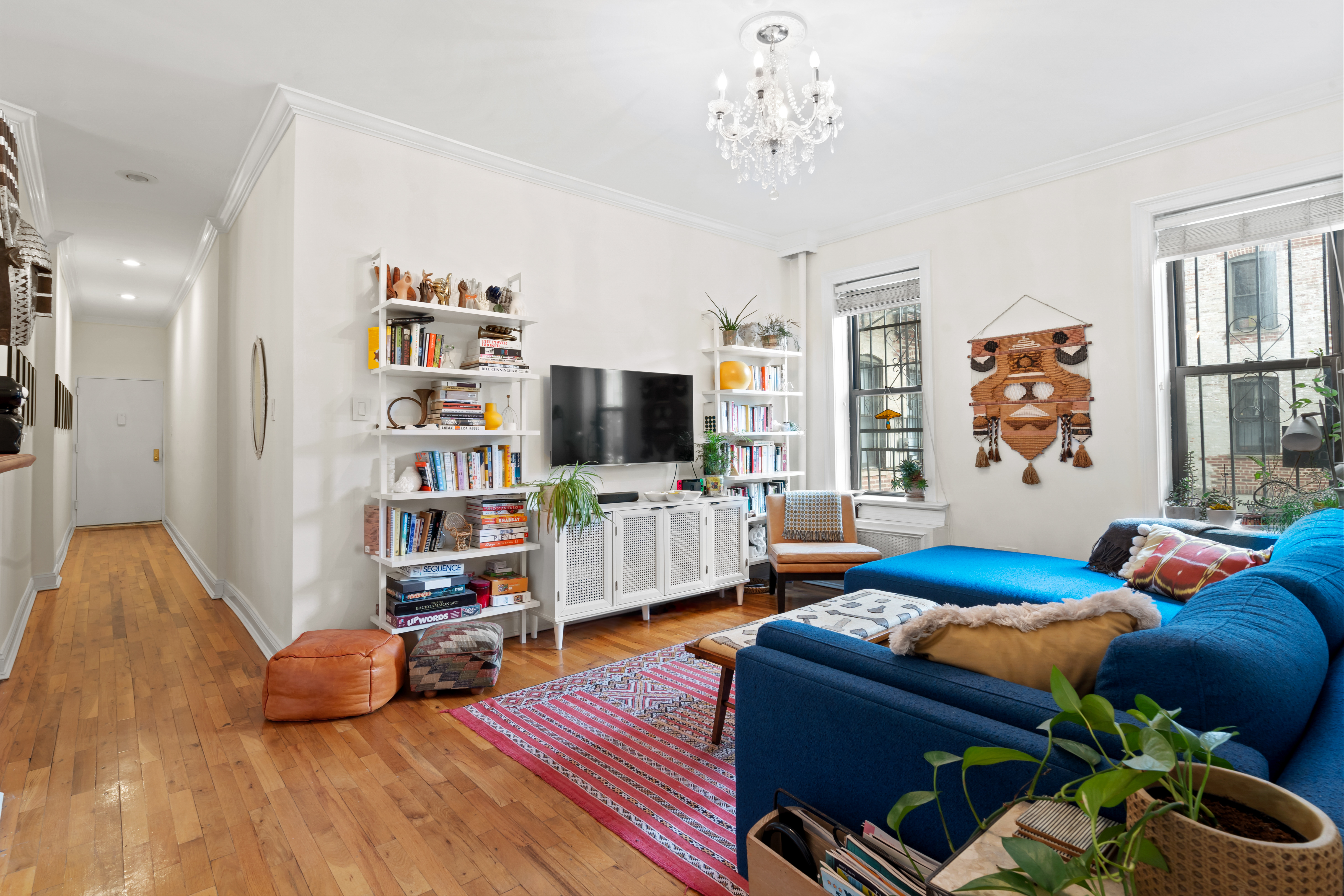 425 Prospect Place, Unit 1J Brooklyn, NY 11238 - Photo 2 of 11 a bedroom with furniture and a flat screen tv