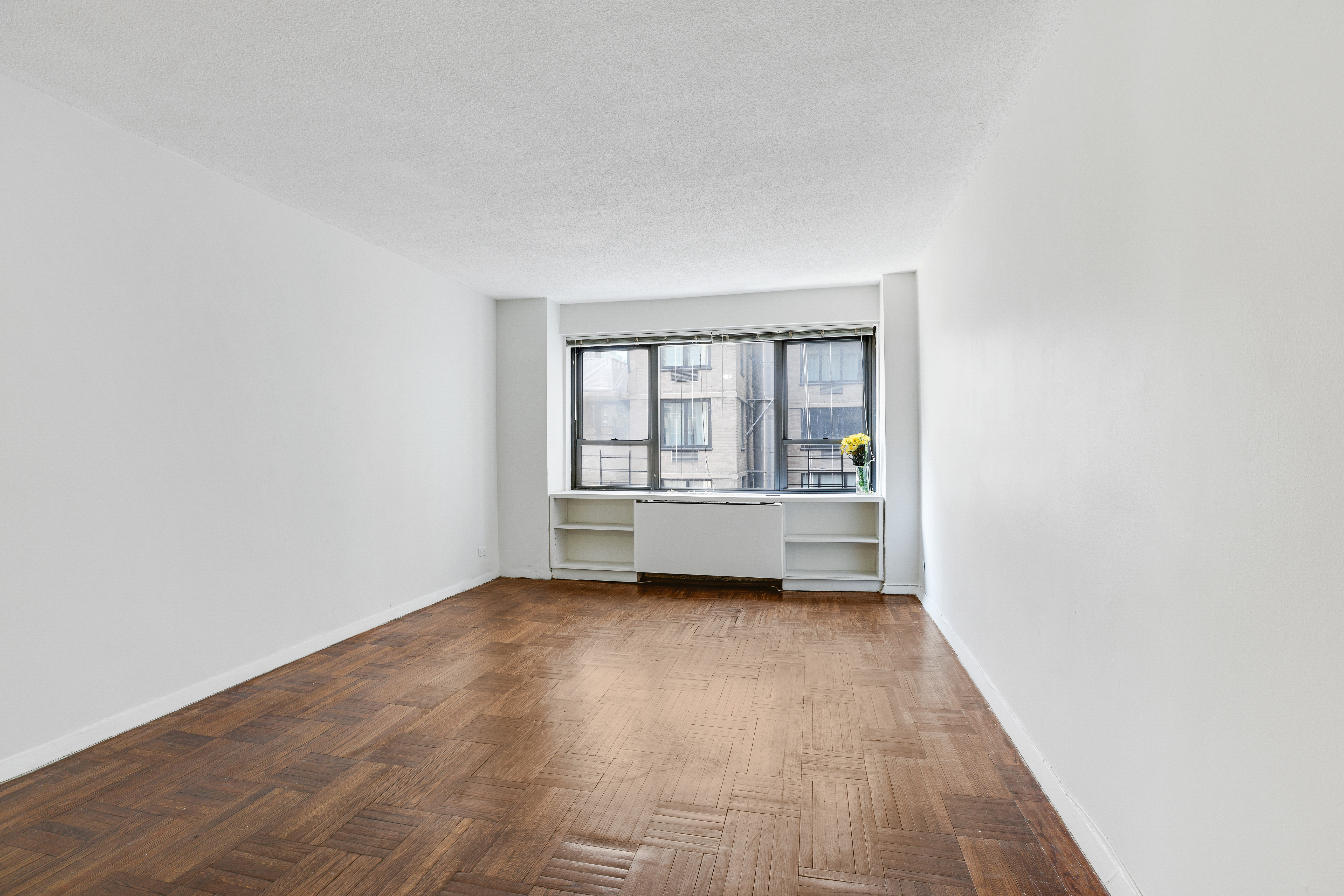 210 East 47th Street, Unit 7J Manhattan, NY 10017 - Photo 5 of 12 a view of an empty room with a window