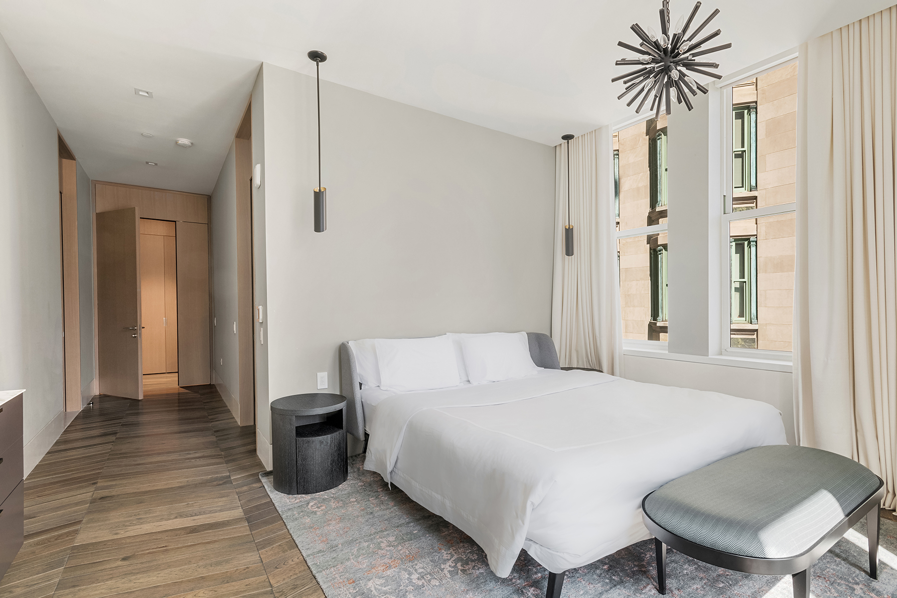 49 Chambers Street, Unit 11D Manhattan, NY 10007 - Photo 9 of 30 a bedroom with a bed and a chandelier