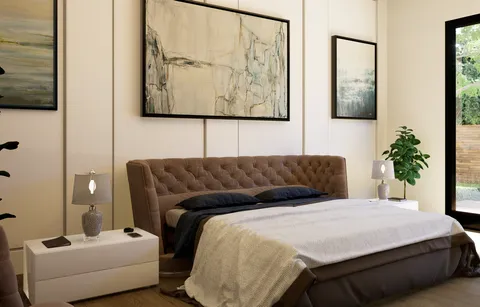 a bedroom with a bed and a painting on the wall