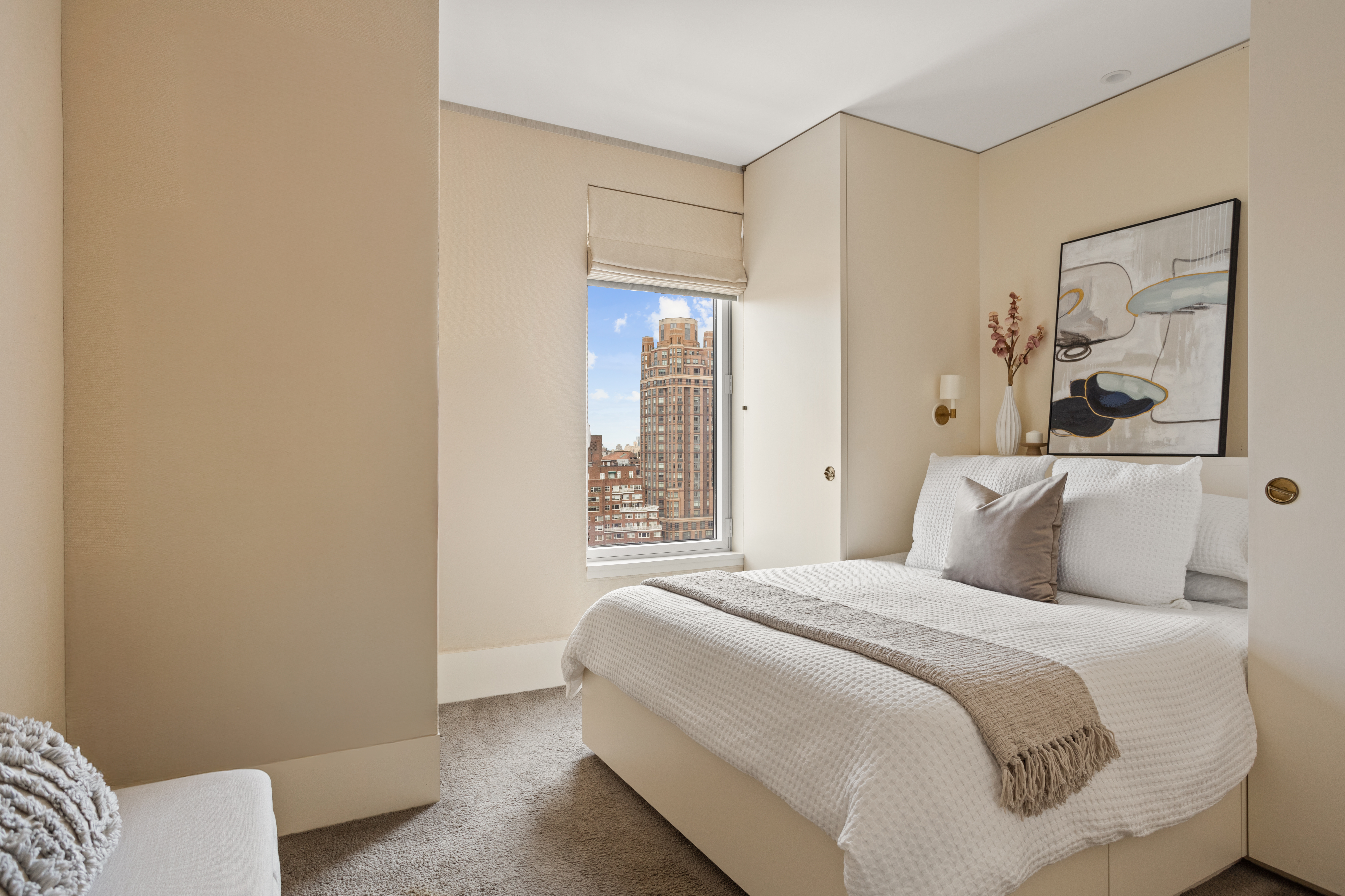 255 East 74th Street, Unit 21B Manhattan, NY 10021 - Photo 17 of 40 a bedroom with a bed and a painting on the wall