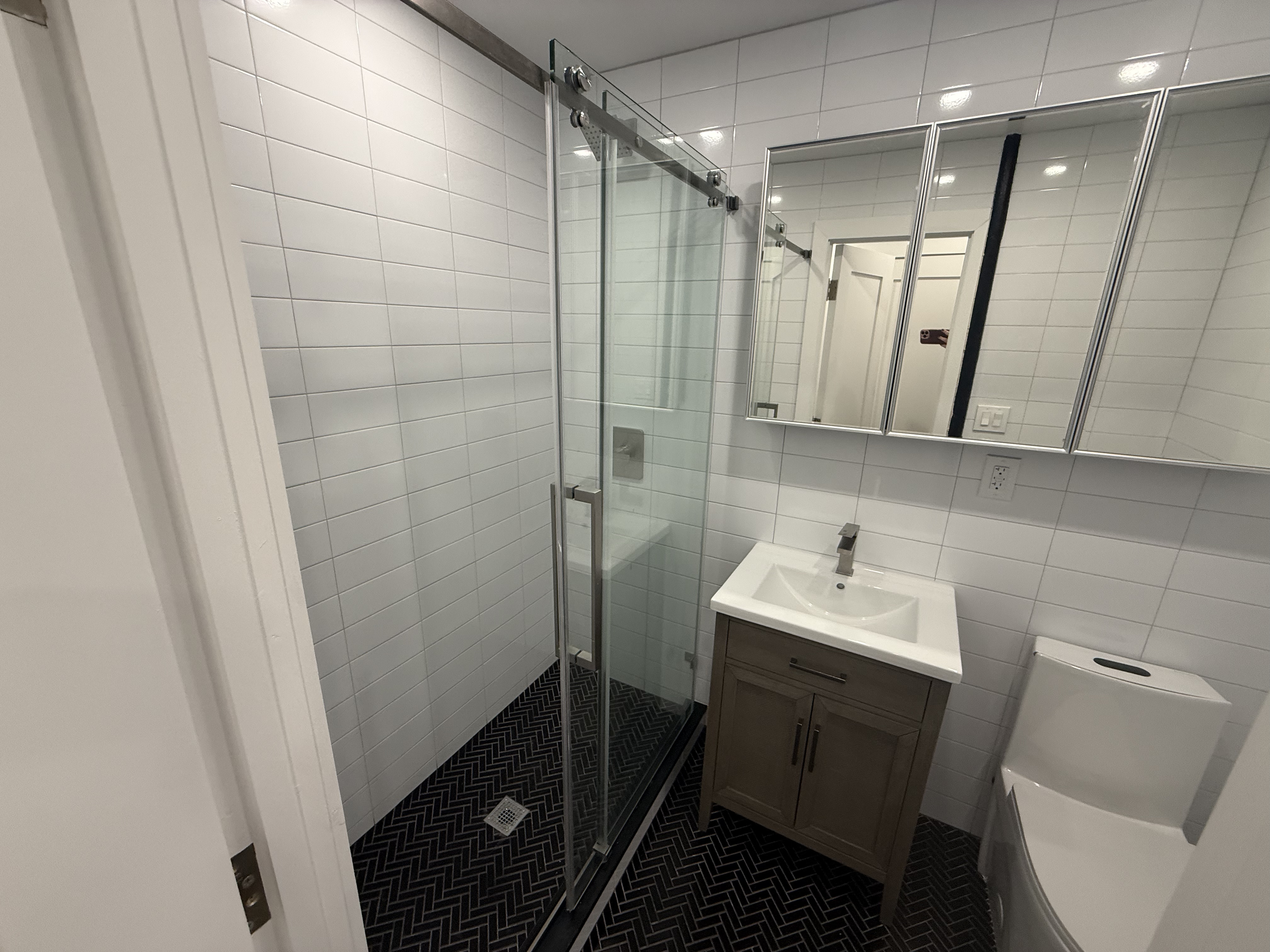 316 West 19th Street, Unit 4W Manhattan, NY 10011 - Photo 5 of 7 a bathroom with a sink a toilet and a mirror