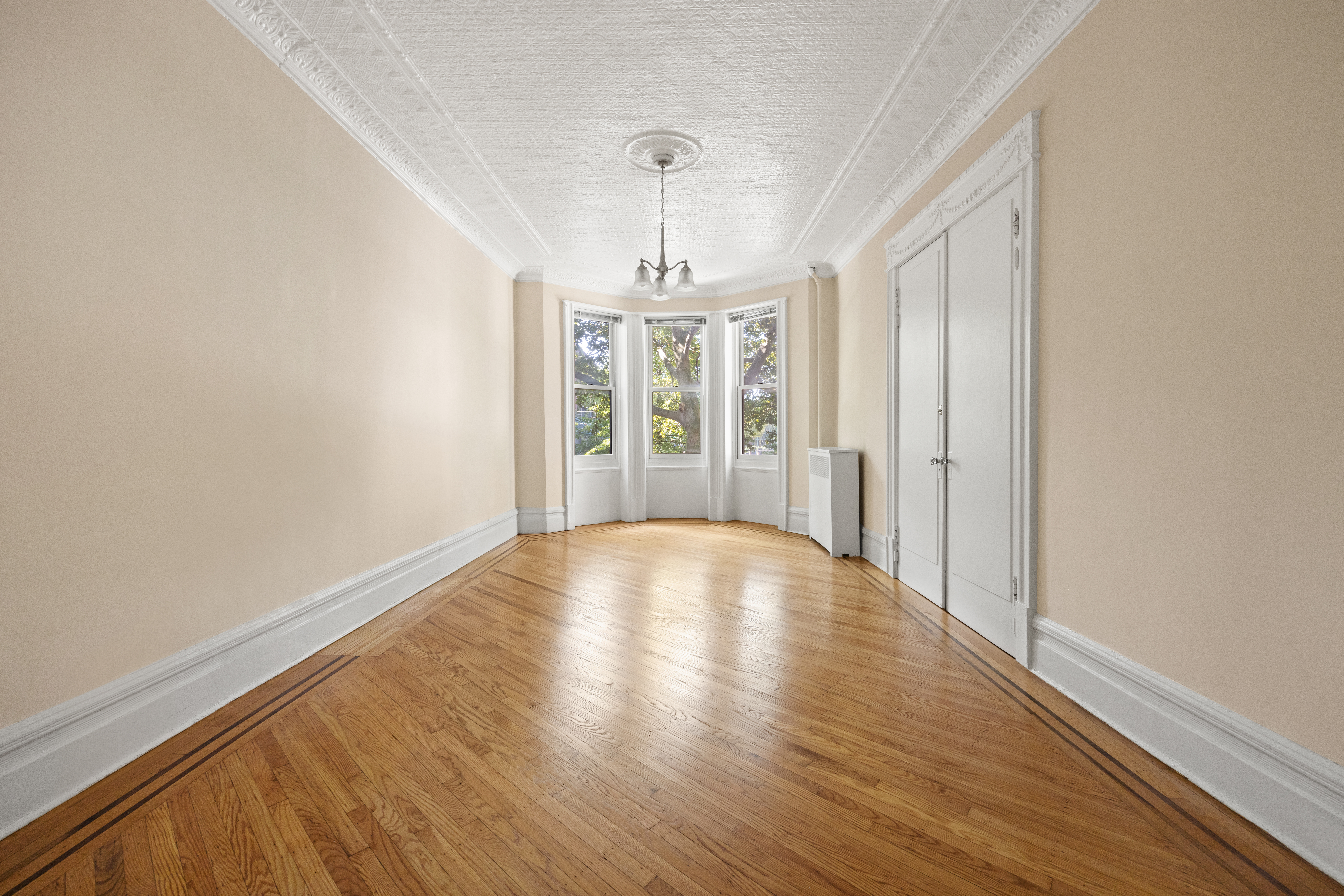 273 Windsor Place Brooklyn, NY 11218 - Photo 3 of 29 wooden floor in an empty room with a window
