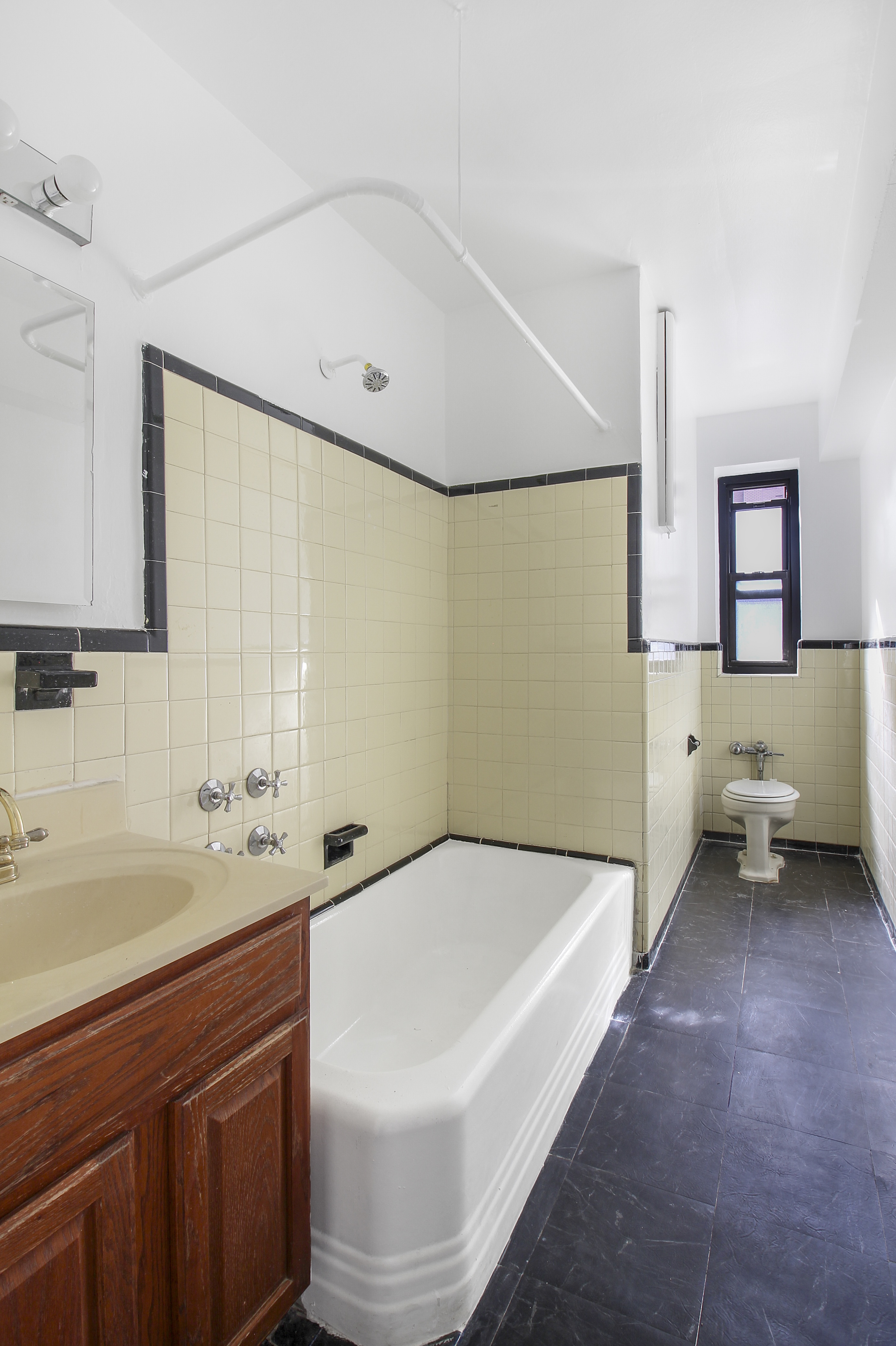 315 East 56th Street, Unit 5H Manhattan, NY 10022 - Photo 9 of 9 a bathroom with a sink and a large mirror