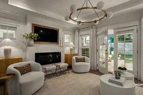 a living room with furniture a fireplace and a flat screen tv