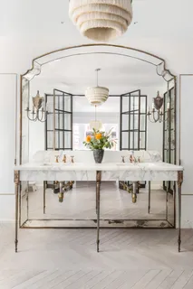 a view of a dining table chairs window and chandelier