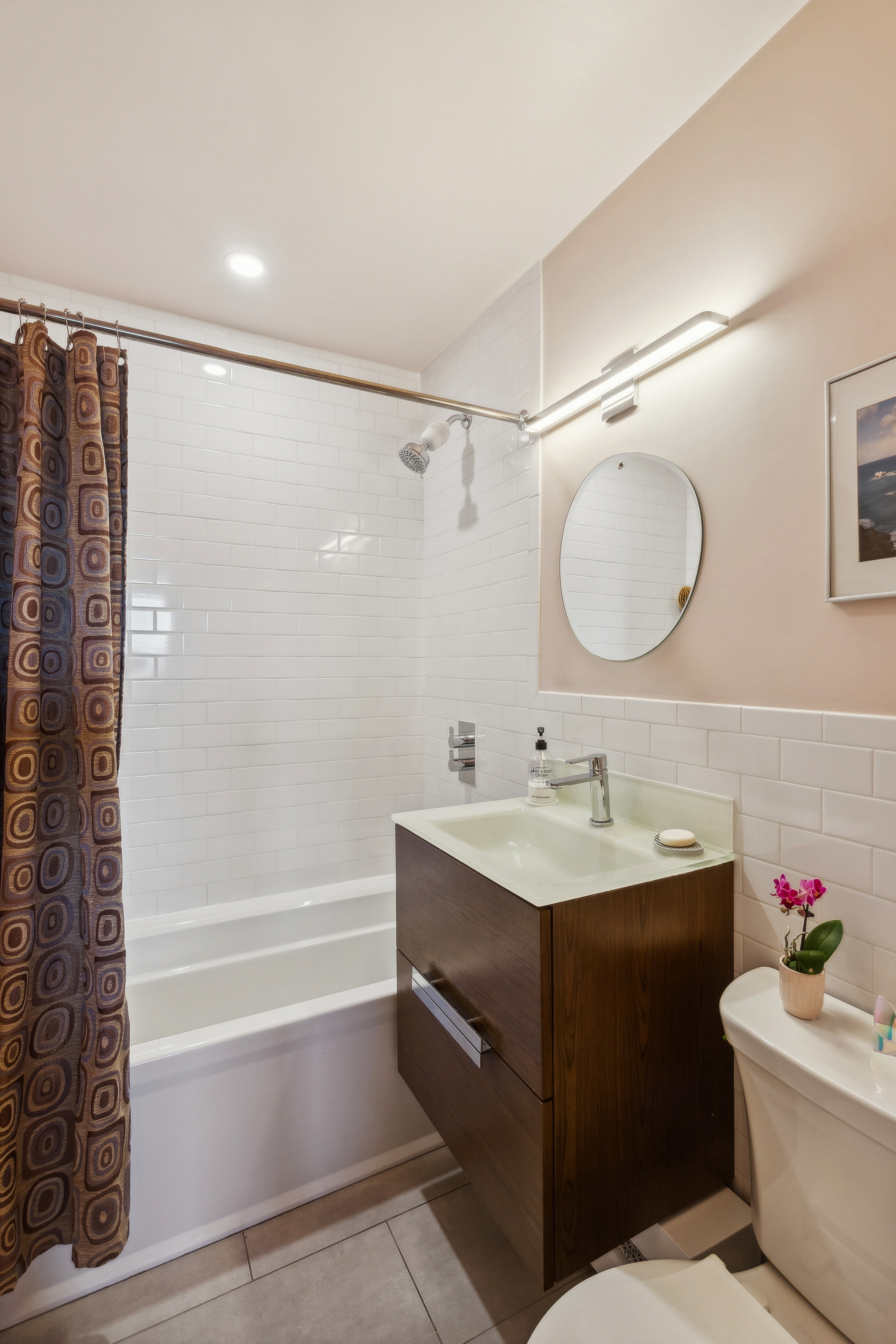 210 East 15th Street, Unit PHD Manhattan, NY 10003 - Photo 9 of 12 a bathroom with a bathtub shower sink vanity and toilet