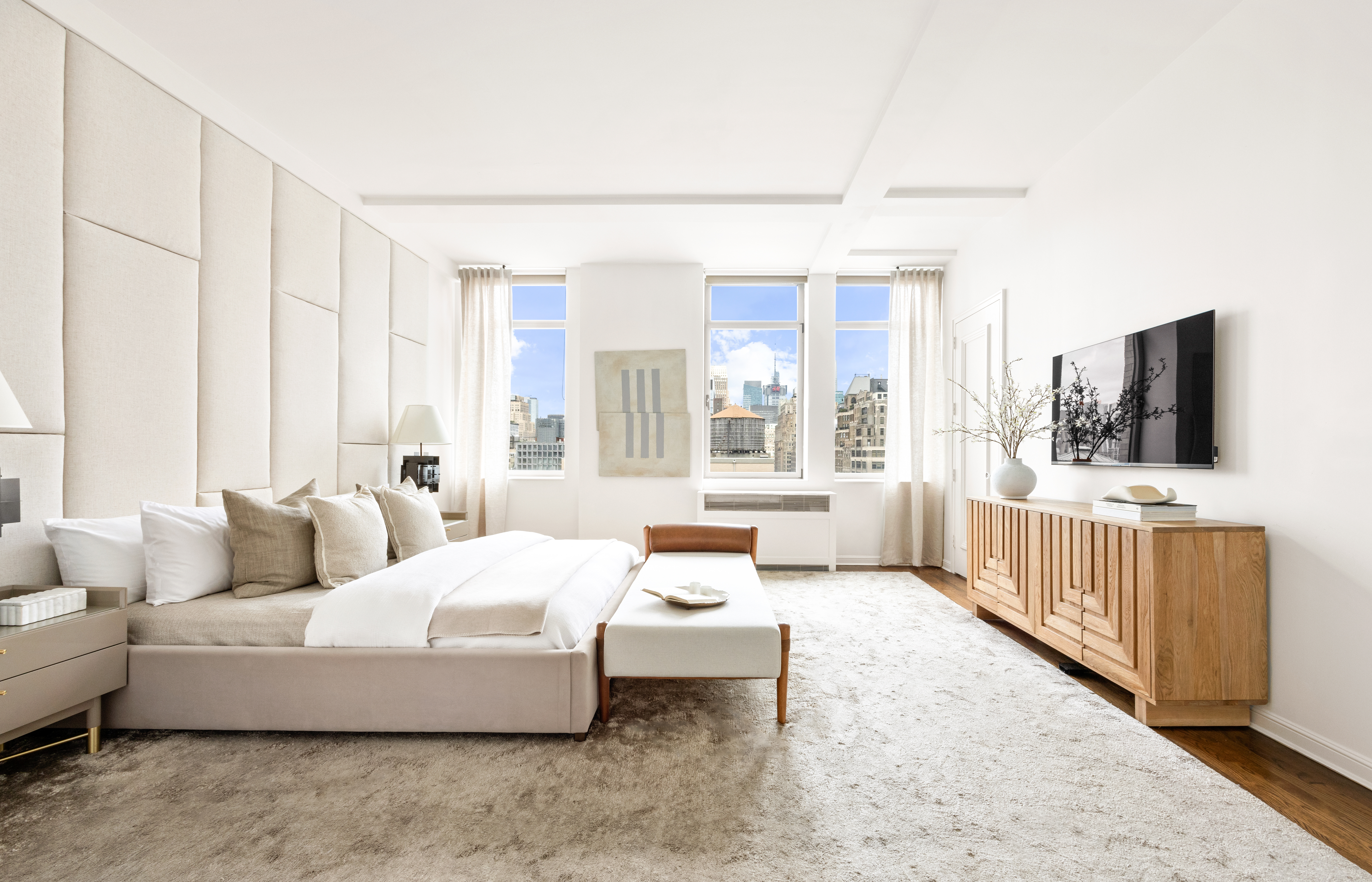 252 7th Avenue, Unit 17I Manhattan, NY 10001 - Photo 9 of 17 a spacious bedroom with a bed and a flat screen tv